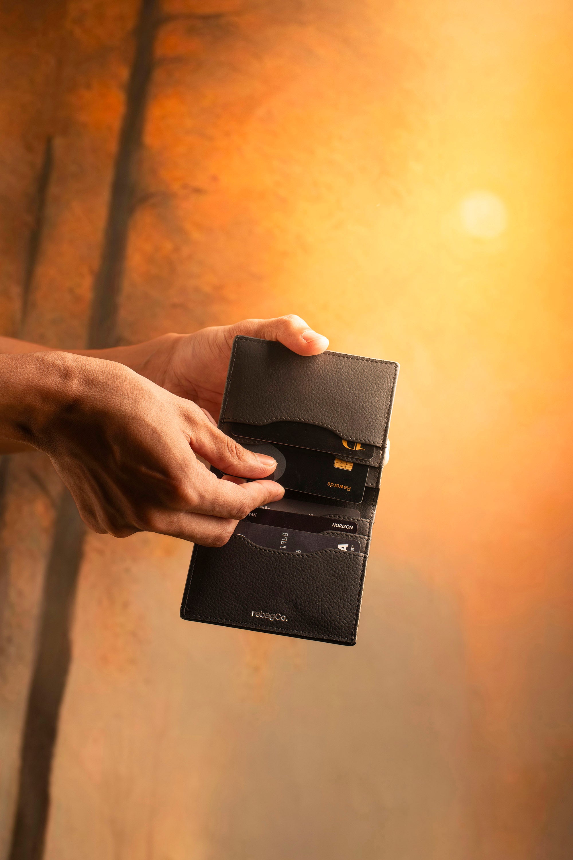 RebagCo Slim Edit Wallet black – lifestyle in-hand shot